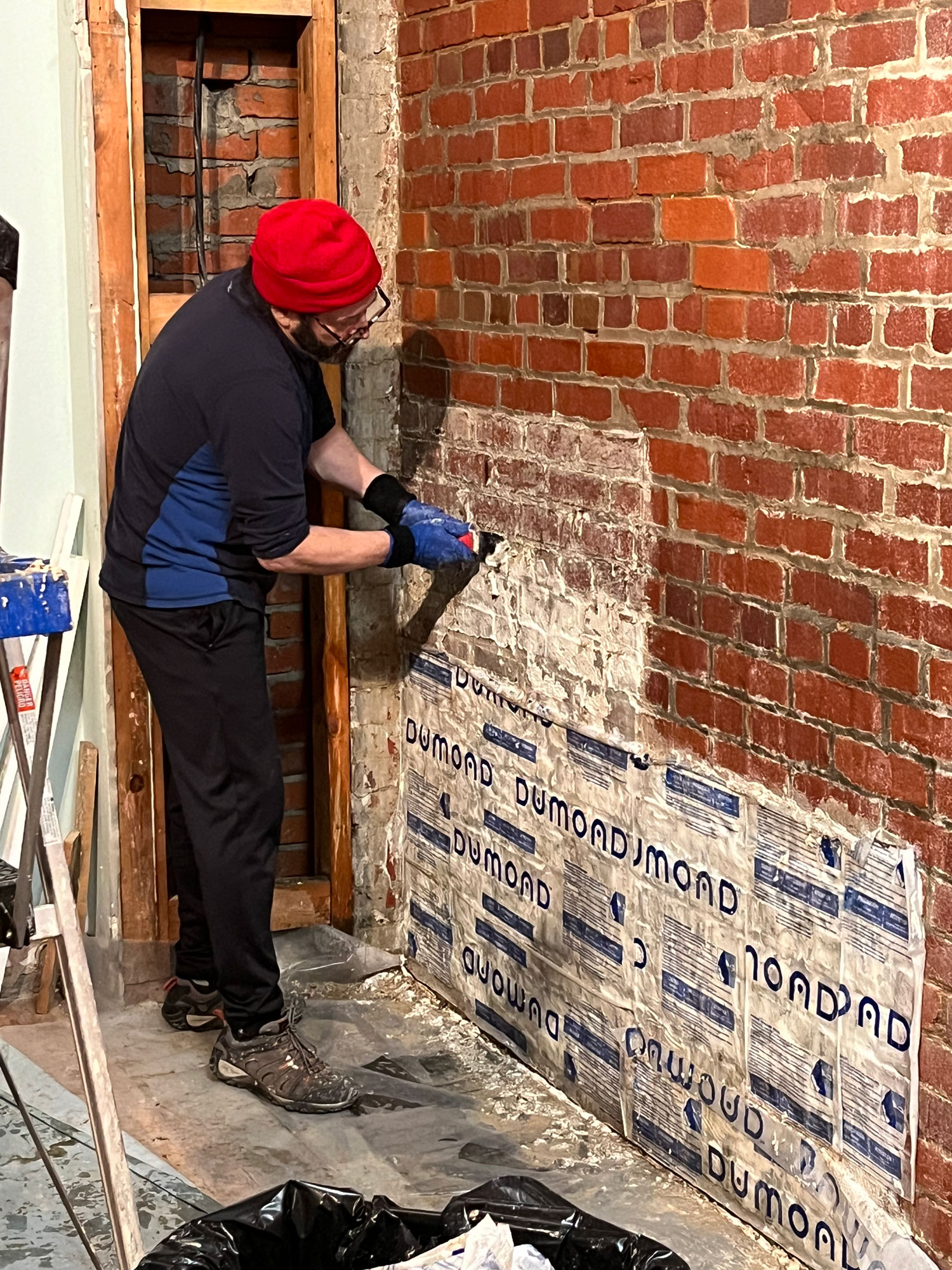 Dave scraping bricks